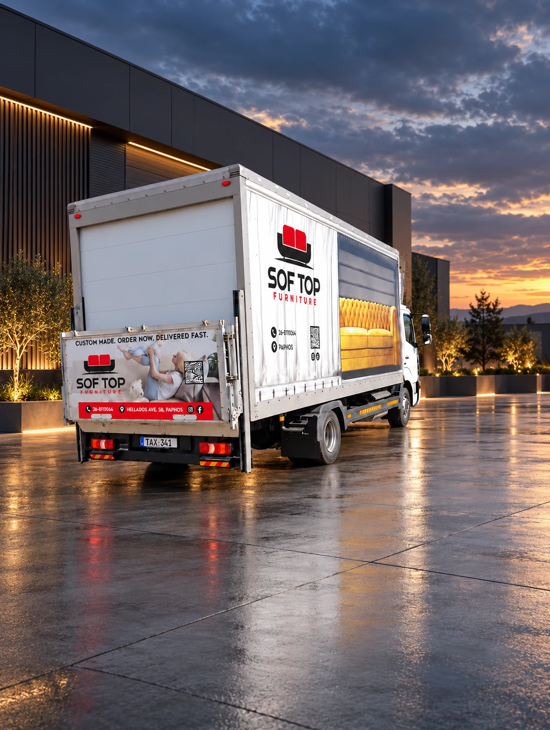 Rear three-quarter view showing SOF TOP Furniture printed vinyl graphics and branded tail lift